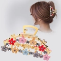 Golden alloy hair claw clip with colorful flowers and rhinestones on a female model - Crystal Rain Flower Style