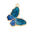 Dettaglio di ciondolo a farfalla blu glitterata con placcatura in oro per gioielli - Blu