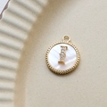 Macro view of gold plated round shell pendant with zircon letter I inlay detail - I Round