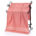 Thick coral pink cotton bath towel with golden jacquard border hanging on a rack - Gold Wire Jacquard Hand Towel (Pink) / 34*74cm