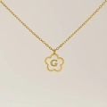 Golden four-leaf clover necklace with shell inlay and letter G pendant detail - Letter G