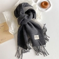 Detail view of charcoal and light grey reversible scarf with tassels and fabric label - Marl Grey