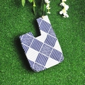 Japanese style linen wrist bag with blue wave patterns on a green grass background - Japanese Squares