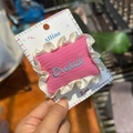 Detailed close-up of a pink knitted hair bow with white lace and blue embroidery - White Satin Ballet Style Rose Pink Letter Duckbill Clip