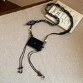 Mini black rectangular crossbody bag with paisley scarf strap and wooden bead accents - Necklace-Black