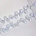 Macro shot of light blue faceted crystal glass drop beads with precision cut for jewelry - 6mm/Approx 89pcs / Light Blue Gray