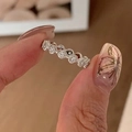 Close-up of a silver brushed eternity ring with pavé diamonds held between fingers - Silver Full Rhinestone Ring (J5237)
