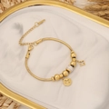 Detail of a gold snake chain bracelet with flower pendants on marble tray - Flower Charms (4#)