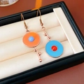 Detail view of vintage asymmetric round earrings in bronze with orange and blue enamel - Ear Hook-Orange-Blue