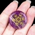 Handheld amethyst crystal disc featuring golden Metatron cube sacred geometry - Amethyst