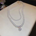 Double-layered pearl necklace with rhinestone flower and large pearl pendant charm - White