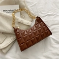 Brown quilted leather baguette bag with a gold chain strap on a white tweed blazer - Dark Brown