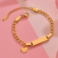 Detail of golden stainless steel ID bracelet with heart pendant on pink background - Gold Heart