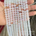 Translucent white round beads with blue glow finish for DIY jewelry making projects - Opaline Glass Beads
