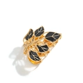 Elegant gold metal hair claw clip featuring black enamel leaf design on white background - Leaf Design / Black