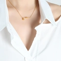 Elegant gold titanium necklace featuring a knotted rope pendant and polished bead detail - 40+5cm Necklace / Gold