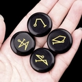Hand holding four black agate stones with golden archangel symbols and cosmic elements - Set of 4 / Obsidian