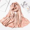 Detailed view of a pink satin headscarf styled with perfume and lifestyle magazines - 180*70cm / Dark Khaki
