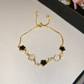 Detail of gold adjustable bracelet with black and zircon-paved flower charms - Five-Petal Flower / Gold-Black