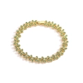 Detailed view of a gold flower bracelet featuring vibrant green cubic zirconia accents - Gold Bracelet with Green Zircon