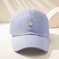 Detailed close-up of daisy embroidery on lilac cotton twill baseball cap fabric - Sky Blue
