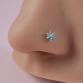 Detail of silver flower nose stud with turquoise petals and clear gemstone center - Blue Pointed Petal Flower