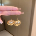 Detail of hand holding vintage gold heart-shaped earrings with a brushed metal texture - Brushed Heart Shape Style (42#)