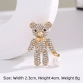 Golden teddy bear brooch with white rhinestones and a hanging pearl charm - Teddy Bear Pearl Gold