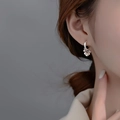 925 silver hoop earrings featuring hanging metal beads worn by a female model - Silver