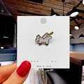 Detail of a pixel-style unicorn enamel pin held by hand on a white display card - 9*Pixel Unicorn Pin