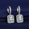 Silver square-cut cubic zirconia stud earrings with halo setting on blue fabric - White Diamond Earrings With Led-112