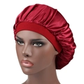 Silky red satin sleep bonnet with wide band for hair protection on model head - One Size / Burgundy