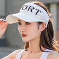 White knitted sports sun visor with SPORT embroidery worn by a model in outdoor setting - White