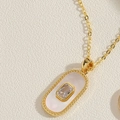 Collier doré vintage avec pendentif ovale en nacre et une pierre de zircon rectangulaire - Collier Pendentif Ovale en Coquillage