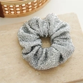 Macro detail of silver shiny scrunchie with metallic glitter texture for hairstyles - Silver