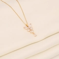 Macro detail of a golden butterfly pendant featuring sparkling marquise cut zircon stones - White