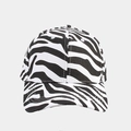Macro shot of breathable eyelets and black and white zebra pattern on cotton baseball cap - Black Zebra Print
