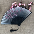 Japanese folding fan with pink cherry blossoms and black tassel on linen background - No.10 Black Grey Gradient Cherry Blossom