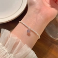 Close-up of minimalist silver bead chain bracelet with a light purple zircon pendant - Purple Rhinestone Pendant Style (MY31232)