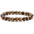 Macro shot of tiger eye stone beads showing natural golden brown textures and glossy finish - Tiger's Eye