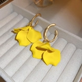 Macro detail of yellow petal earrings with gold textured C-shape hoops on velvet - Yellow Petal