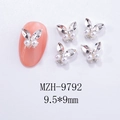 Macro shot of butterfly nail charms with rhinestones and pearls on a silver metal base - White Pearl Silver Base Style (MZH-9792)