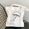 White canvas tote bag featuring a frog under a mushroom umbrella black line art - C7-Frog With Mushroom Umbrella In Rain (No Zipper No Pocket)