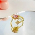 Gold adjustable ring with pink heart gem and zircon star on a reflective surface - Saturn Heart Star Ring (S447) / Pink
