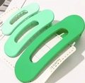Three-piece set of green matte hair clips in varying sizes with oval hollow design - Gradient Green