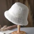 Detailed texture of plush off-white faux fur bucket hat on a wooden stand - 56-58cm (One Size) / Cream