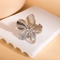 Detailed close-up of a silver flower ring with intricate petals on a stone surface - Silver Flower Shape Open Ring