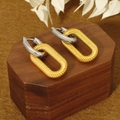 Detailed close-up of two-tone double hoop earrings with textured gold and silver finish - Paperclip Ear Buckle Silver Top Gold Bottom / Two-tone (Silver Top Gold Bottom)