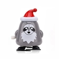 Wind-up grey raccoon toy wearing a red Christmas hat on a clean white background - Wind-up Walking Grey Dog