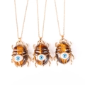 Detailed view of three beetle pendants with brown tiger eye stone and blue evil eye detail - Tiger Eye Stone (No Chain)